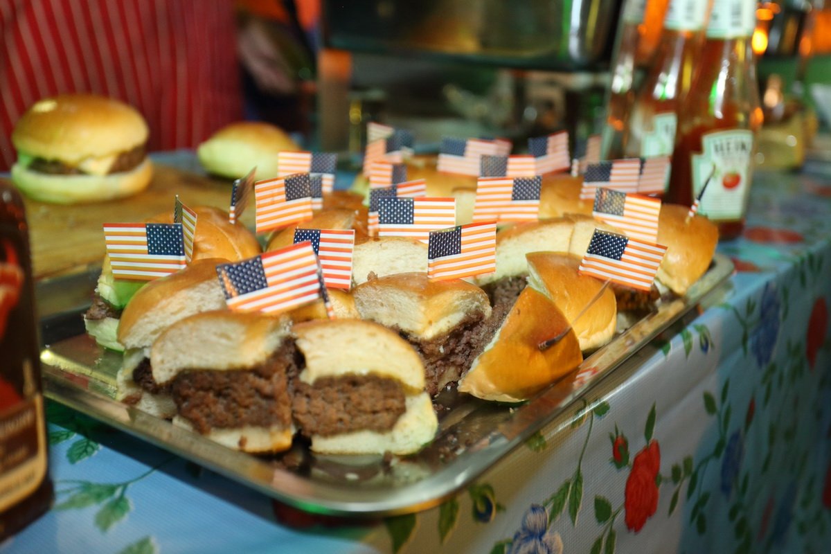 A tray of mini burgers with US flags at Sports on 20